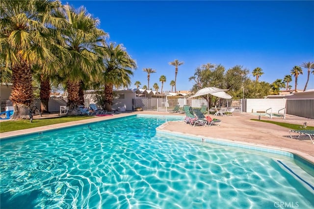 pool featuring a patio area and fence