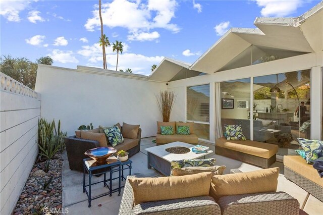 view of patio featuring fence and an outdoor hangout area