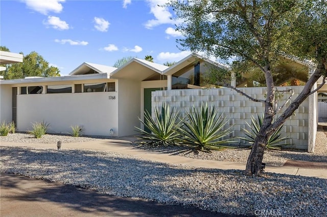 view of front of house featuring a fenced front yard and stucco siding