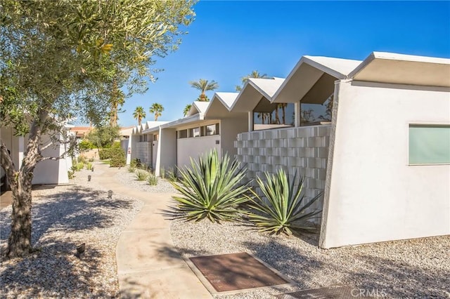 view of side of home featuring a residential view and stucco siding