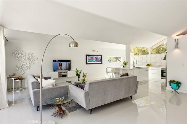 living area featuring lofted ceiling and light tile patterned flooring