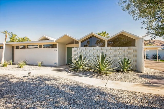 view of front of property featuring a fenced front yard and stucco siding