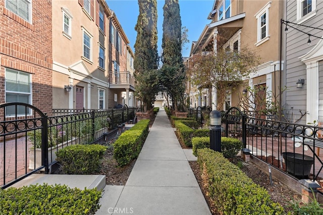 view of community with a residential view and fence