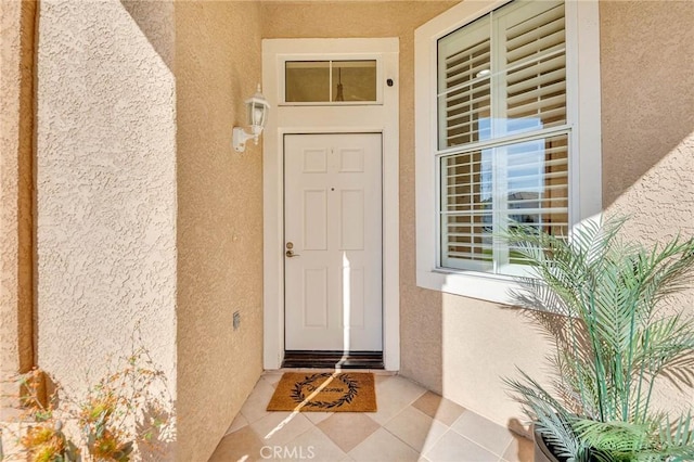 property entrance featuring stucco siding