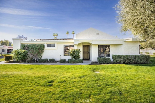 view of front of home featuring a front lawn and stucco siding