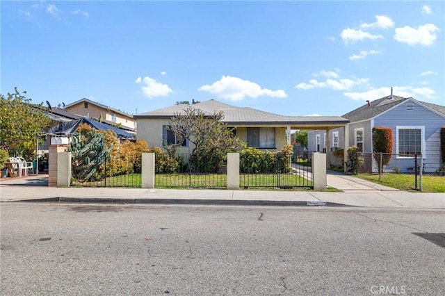 ranch-style house with a fenced front yard and a carport