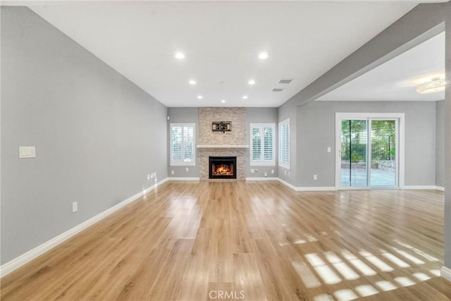 unfurnished living room with light wood finished floors and baseboards