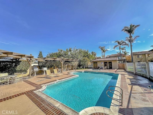 community pool featuring a pergola, fence, and a patio area