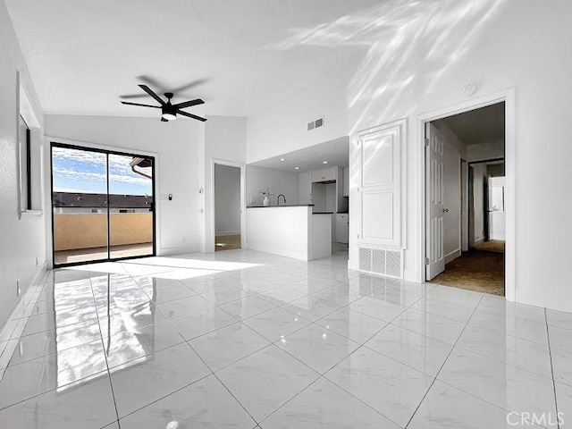 unfurnished living room featuring baseboards, high vaulted ceiling, ceiling fan, and marble finish floor