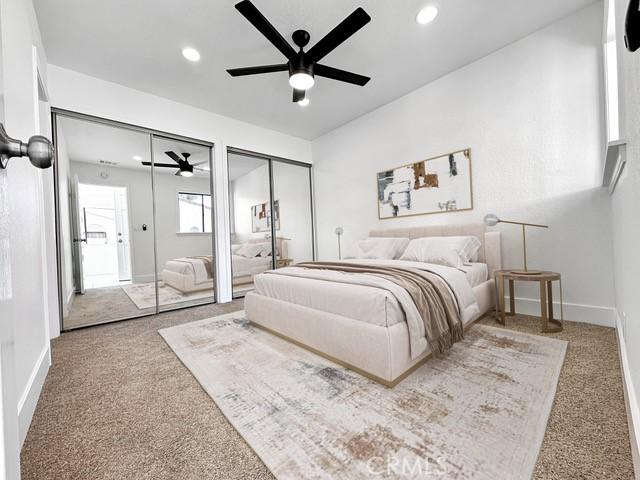 bedroom featuring recessed lighting, two closets, carpet, and baseboards
