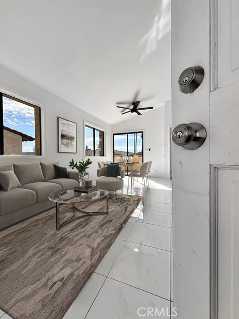living room featuring lofted ceiling and ceiling fan