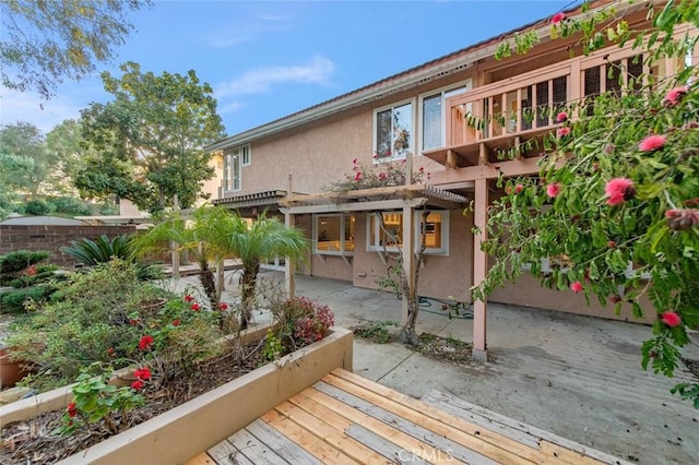 back of property with a patio area, fence, a pergola, and stucco siding