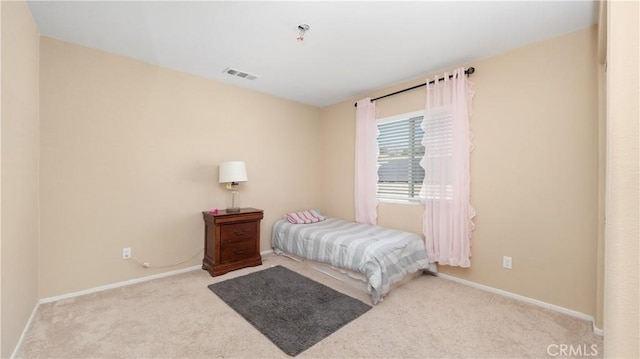 bedroom featuring light colored carpet, visible vents, and baseboards