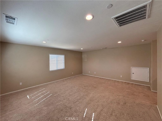 carpeted empty room featuring recessed lighting and visible vents