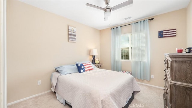 bedroom with light colored carpet, visible vents, and baseboards