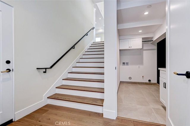 stairway featuring baseboards, wood finished floors, and recessed lighting