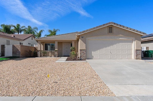 ranch-style house featuring concrete driveway, stone siding, an attached garage, fence, and stucco siding