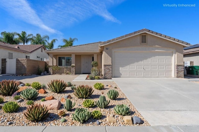 single story home featuring driveway, a garage, stone siding, fence, and stucco siding