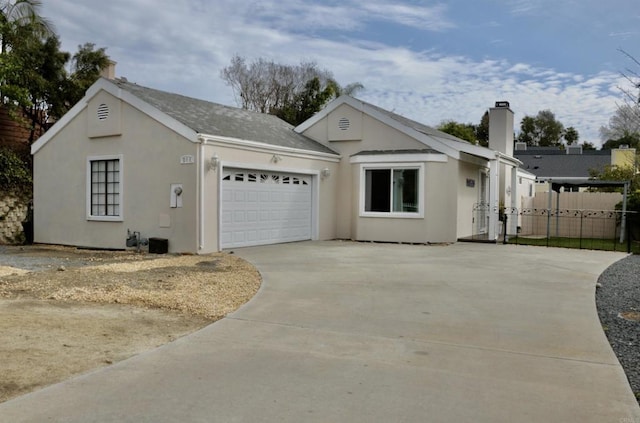 view of front of home featuring concrete driveway, an attached garage, fence, and stucco siding