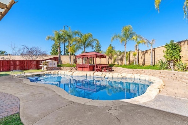 view of swimming pool with a fenced in pool, a fenced backyard, a bar, and a gazebo