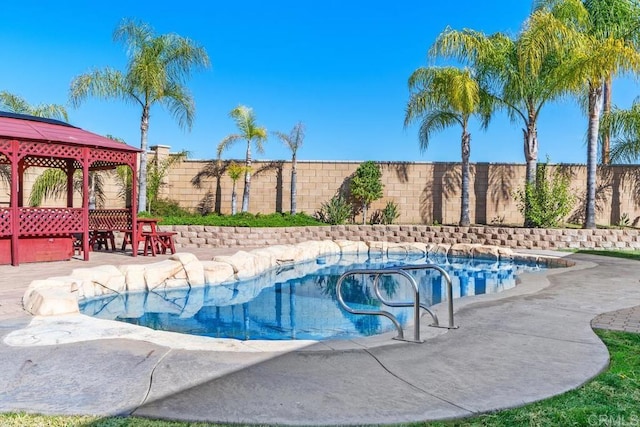 view of pool featuring a gazebo, a fenced backyard, and a fenced in pool