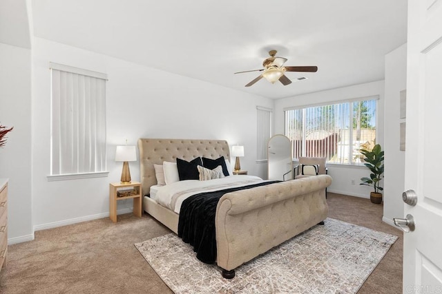 bedroom with light carpet, a ceiling fan, and baseboards