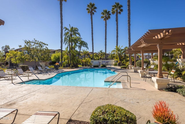 community pool with a patio, fence, and a pergola