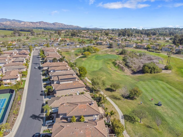 aerial view with view of golf course, a residential view, and a mountain view