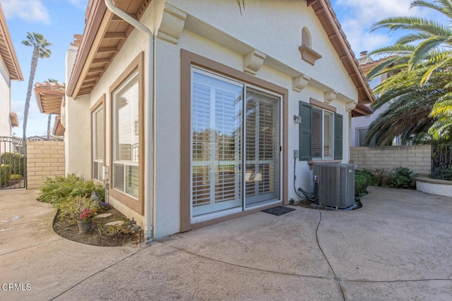 view of patio featuring central AC and fence