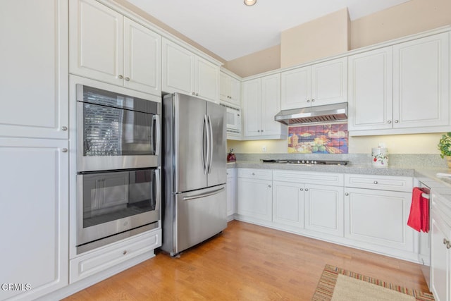 kitchen featuring stainless steel appliances, light countertops, under cabinet range hood, and white cabinetry