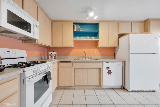 kitchen featuring white appliances, light tile patterned floors, light countertops, light brown cabinetry, and a sink