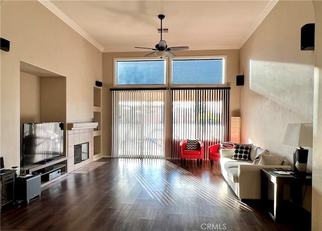 30659 Lajoe St, Menifee, CA 92584 - living area featuring a ceiling fan, wood finished floors, a fireplace, crown molding, and a high ceiling