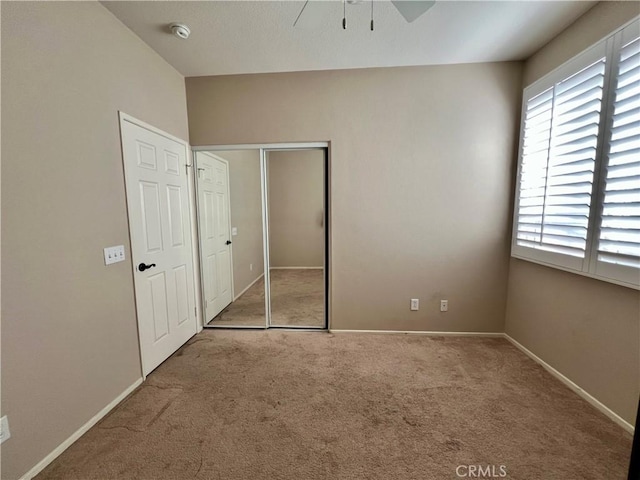 30659 Lajoe St, Menifee, CA 92584 - unfurnished bedroom with carpet, a closet, baseboards, and ceiling fan