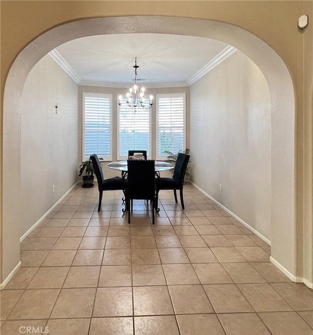 dining room with light tile patterned floors, a notable chandelier, arched walkways, and crown molding