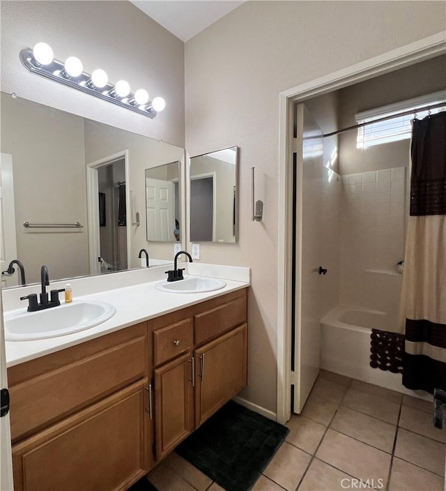 bathroom featuring shower / tub combo, double vanity, a sink, and tile patterned floors