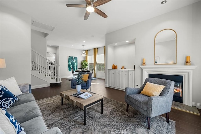 living area with baseboards, dark wood finished floors, and recessed lighting