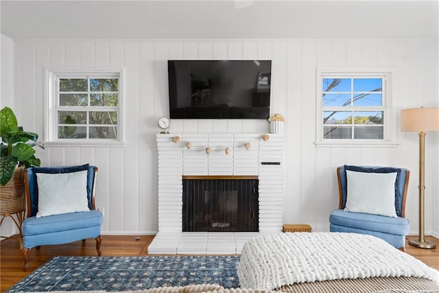 interior space featuring a brick fireplace and wood finished floors