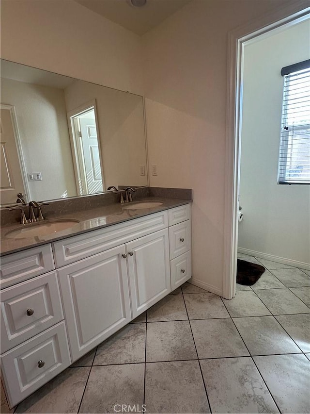 full bathroom with tile patterned floors, a sink, and double vanity