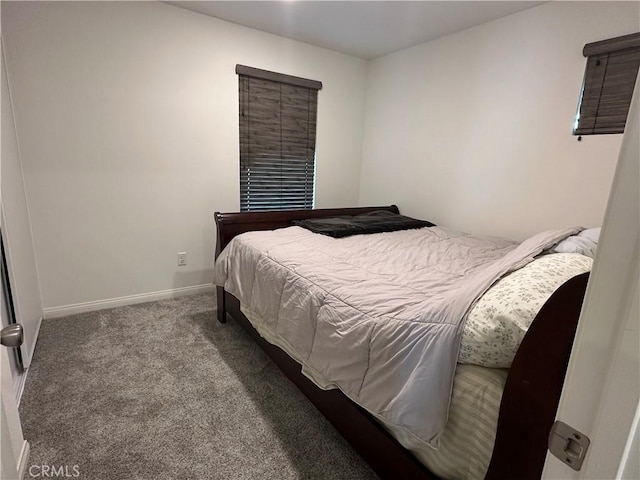 carpeted bedroom featuring baseboards