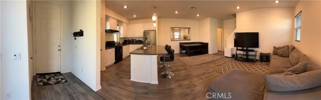 living area with dark wood-style floors and recessed lighting