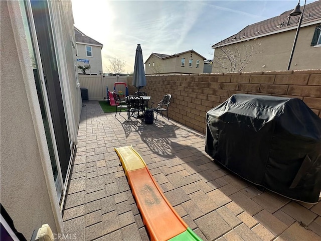 view of patio featuring a fenced backyard, outdoor dining area, and area for grilling