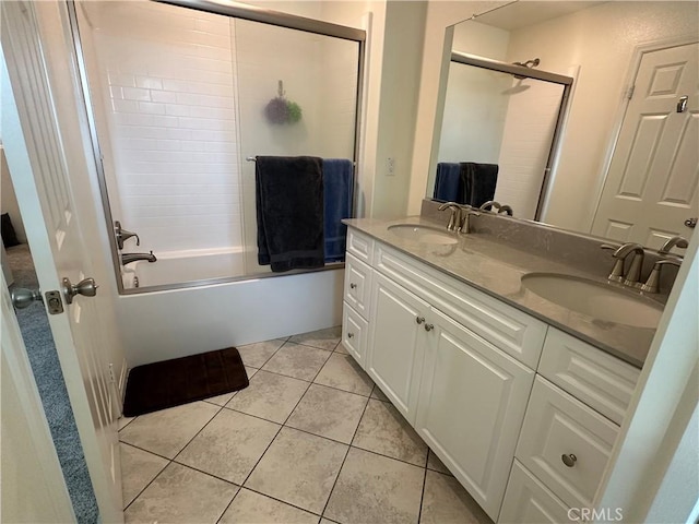 full bath with bath / shower combo with glass door, tile patterned flooring, a sink, and double vanity