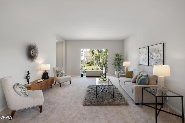 living room featuring light carpet and baseboards