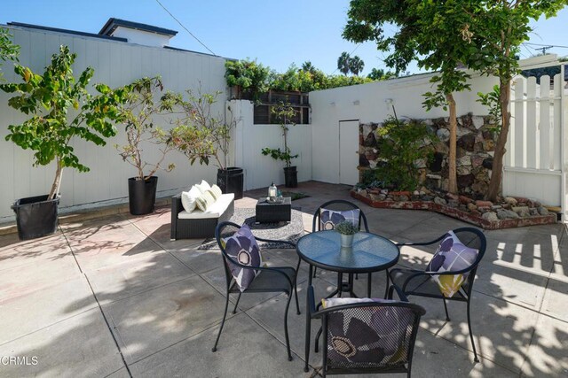 view of patio featuring outdoor dining space and a fenced backyard