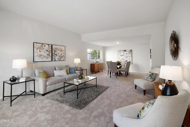 living room featuring light carpet and baseboards