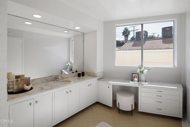 bathroom featuring recessed lighting and vanity