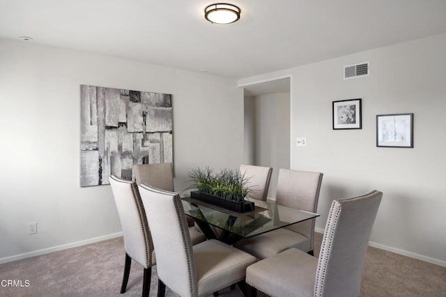 dining room featuring carpet flooring, visible vents, and baseboards