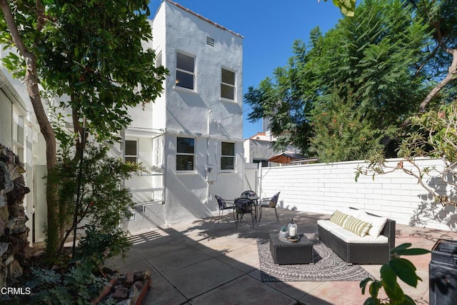 view of patio with outdoor lounge area and a fenced backyard