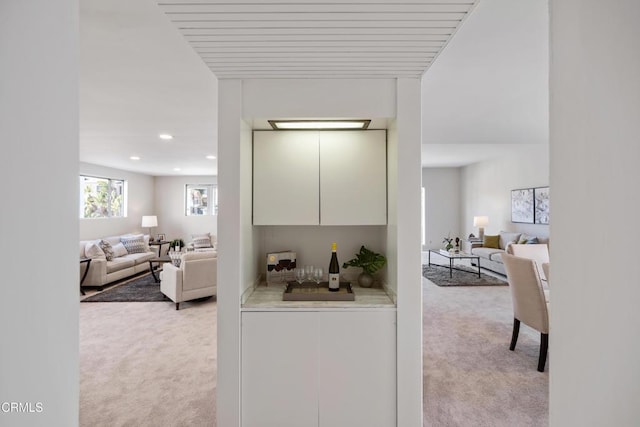 hall featuring light carpet and recessed lighting