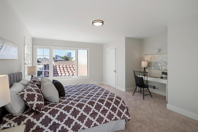 bedroom featuring baseboards, ornamental molding, and light colored carpet